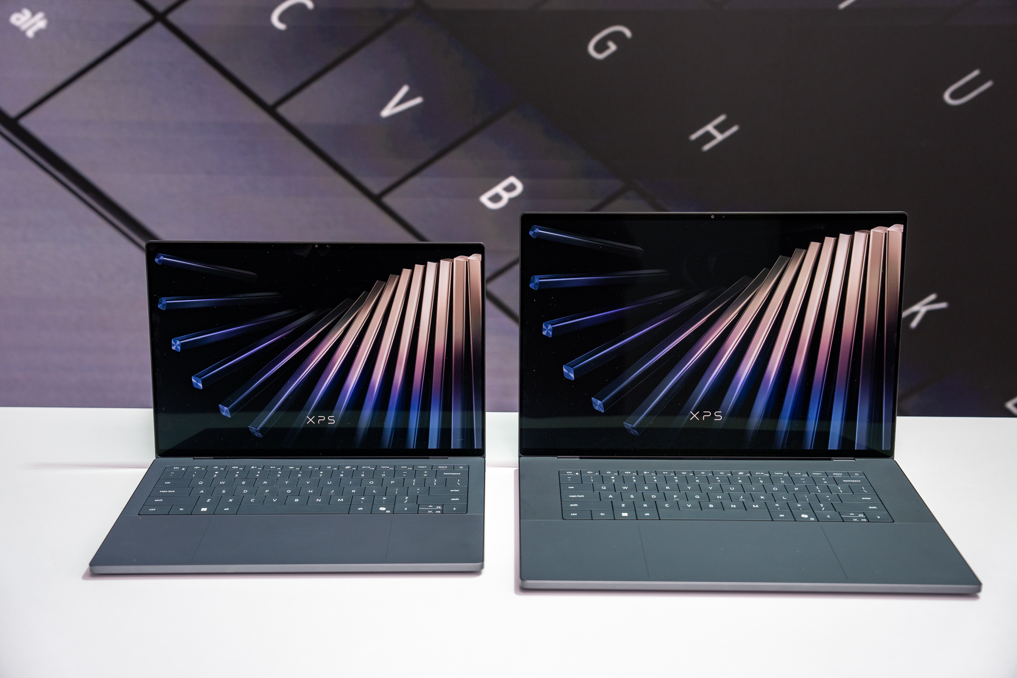 Dell XPS 14 and XPS 16 laptops from the side, showing their thin profile.