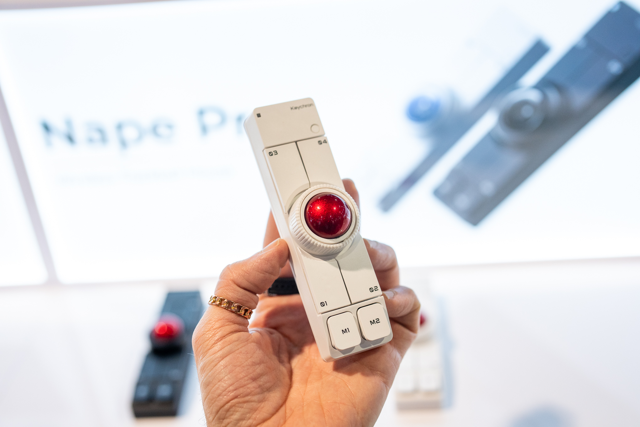 The Keychron Nape Pro is shown from an aerial view, with the trackball at the top center of the device.