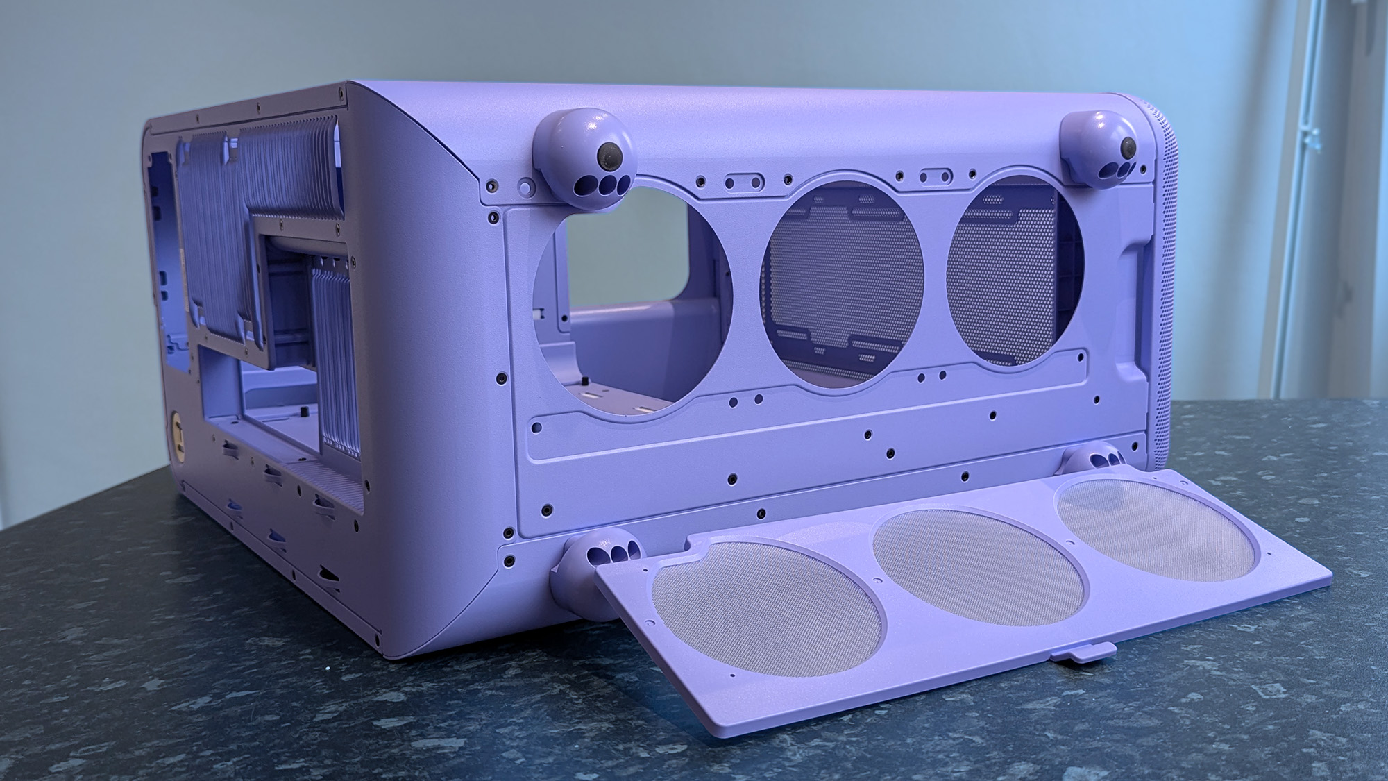 HYTE X50 Taro Milk PC case on a marble desk top, highlighting key features