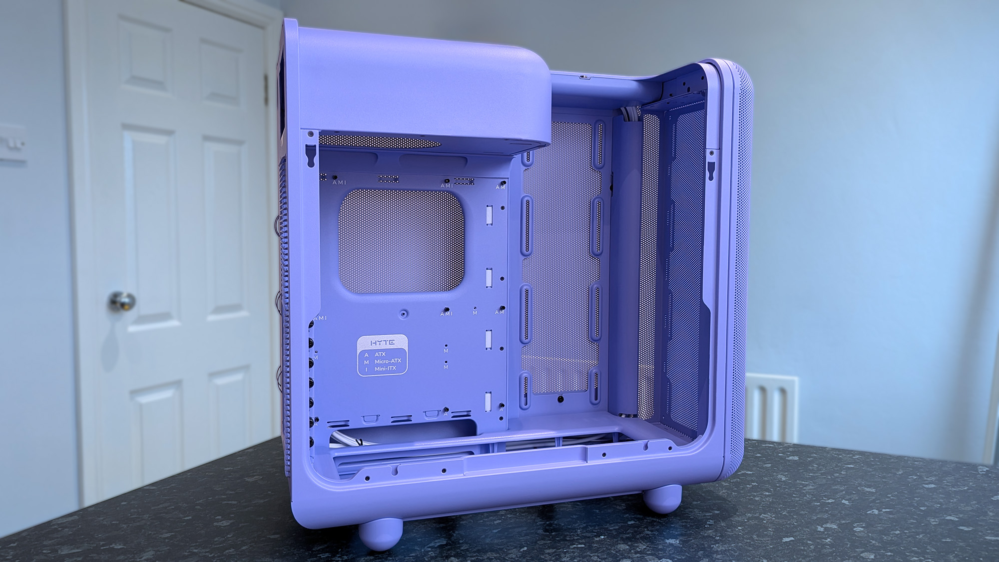 HYTE X50 Taro Milk PC case on a marble desk top, highlighting key features