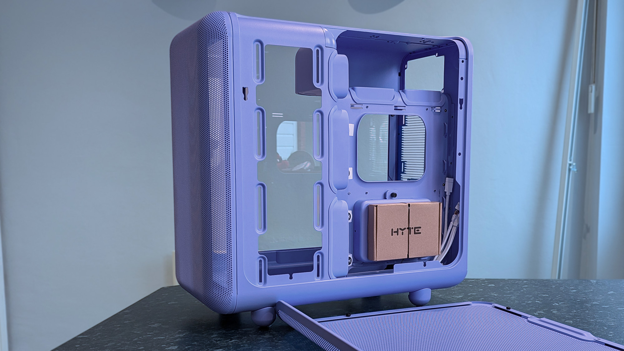 HYTE X50 Taro Milk PC case on a marble desk top, highlighting key features