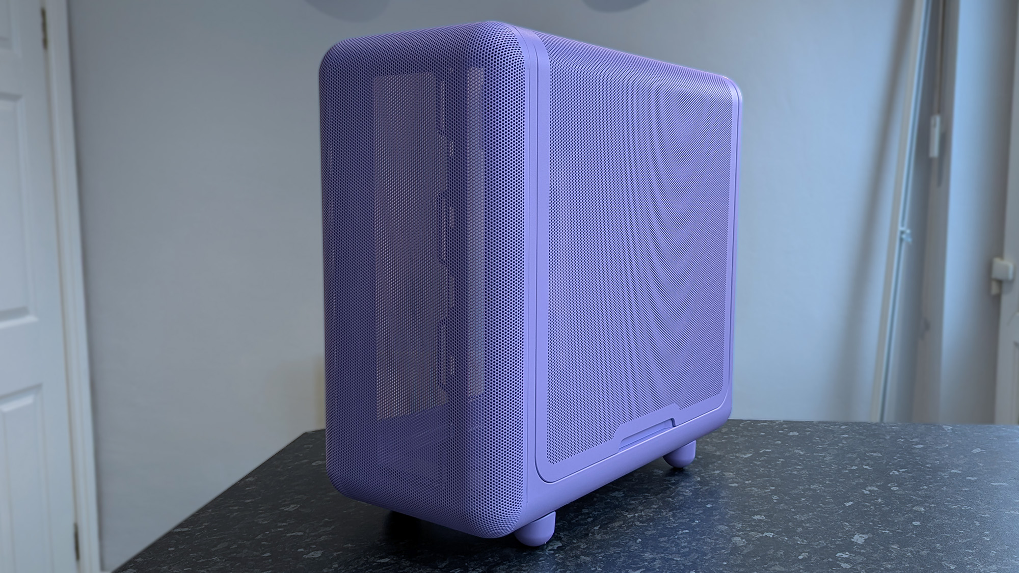 HYTE X50 Taro Milk PC case on a marble desk top, highlighting key features