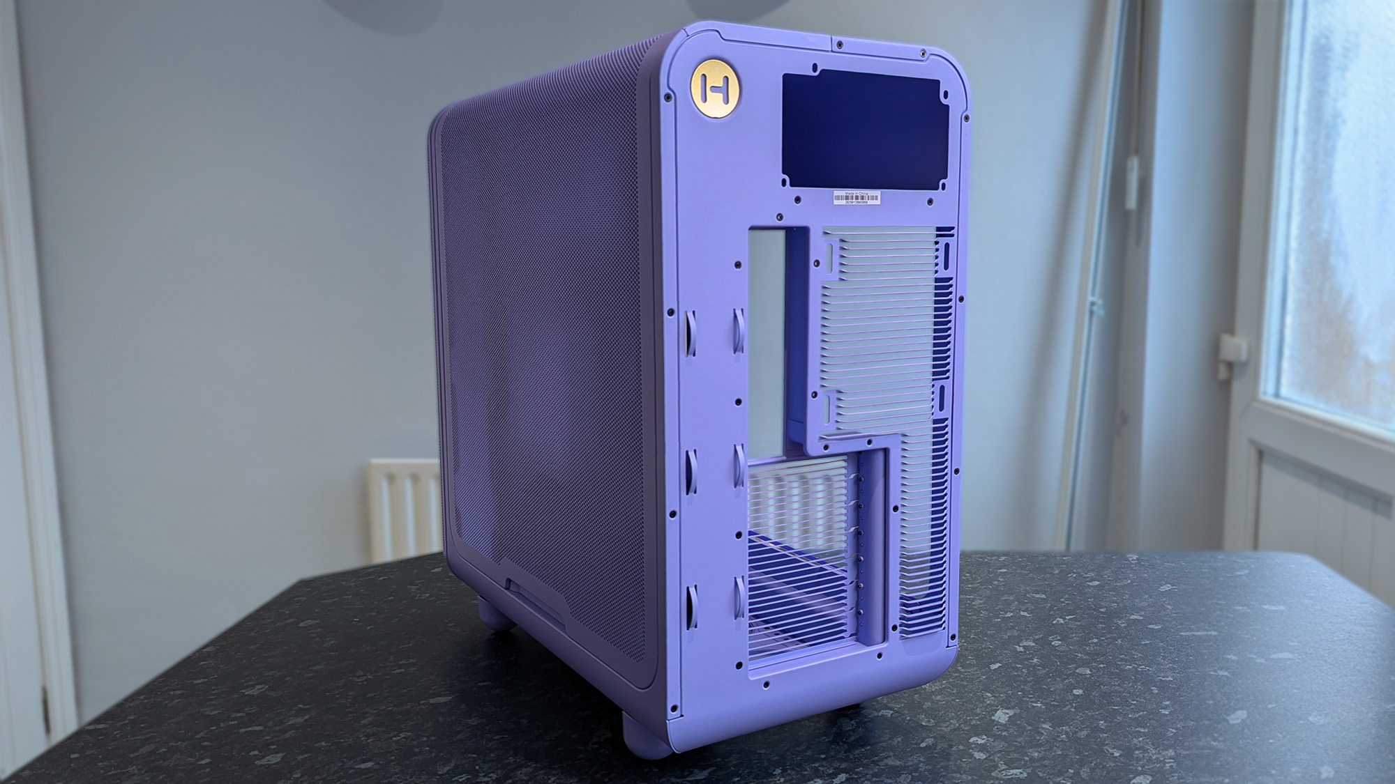 HYTE X50 Taro Milk PC case on a marble desk top, highlighting key features