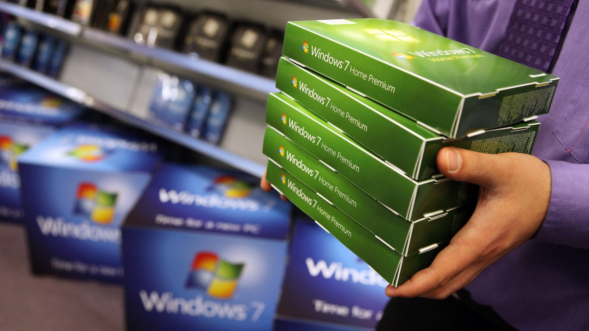 A computer store employee stacks copies of Microsoft's operating system 'Windows 7' ahead of its official launch.