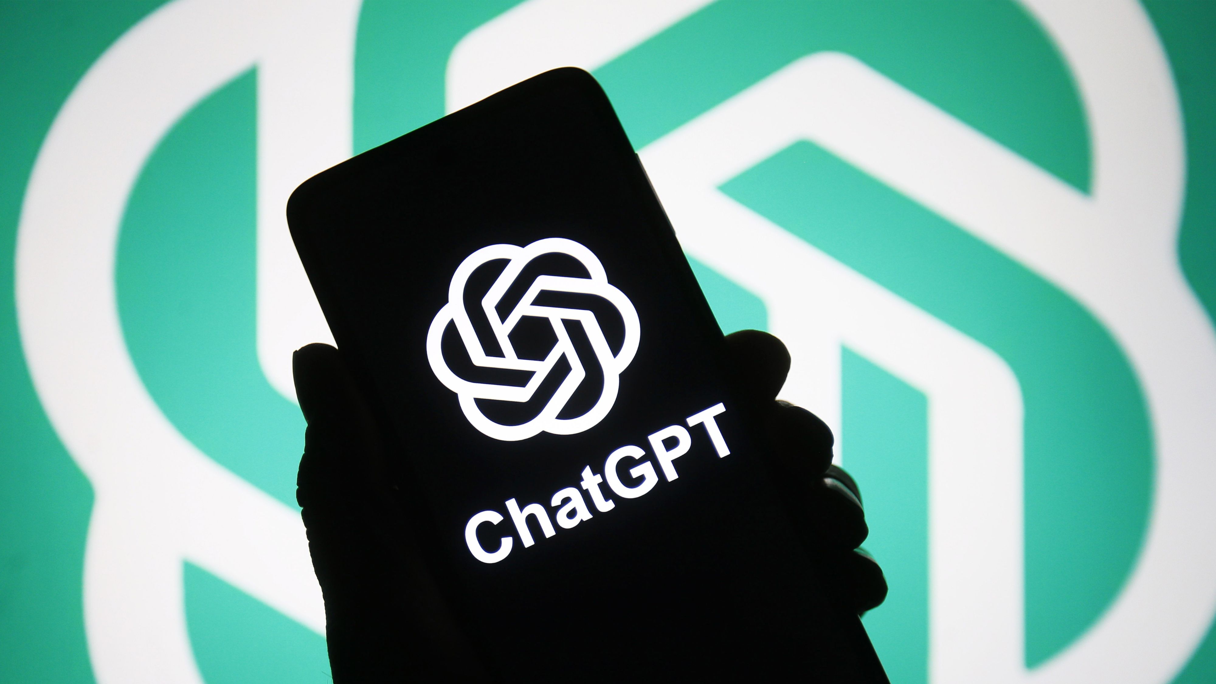 ChatGPT logo of a chatbot launched by OpenAI is seen on a smartphone in a hand.
