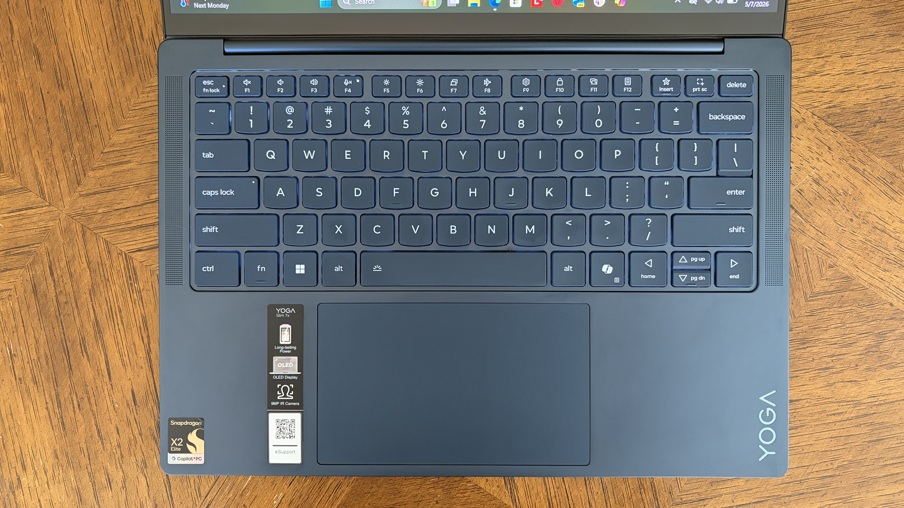 A top-down view of the Yoga Slim 7x (Gen 11)'s keyboard, touchpad, and speakers.