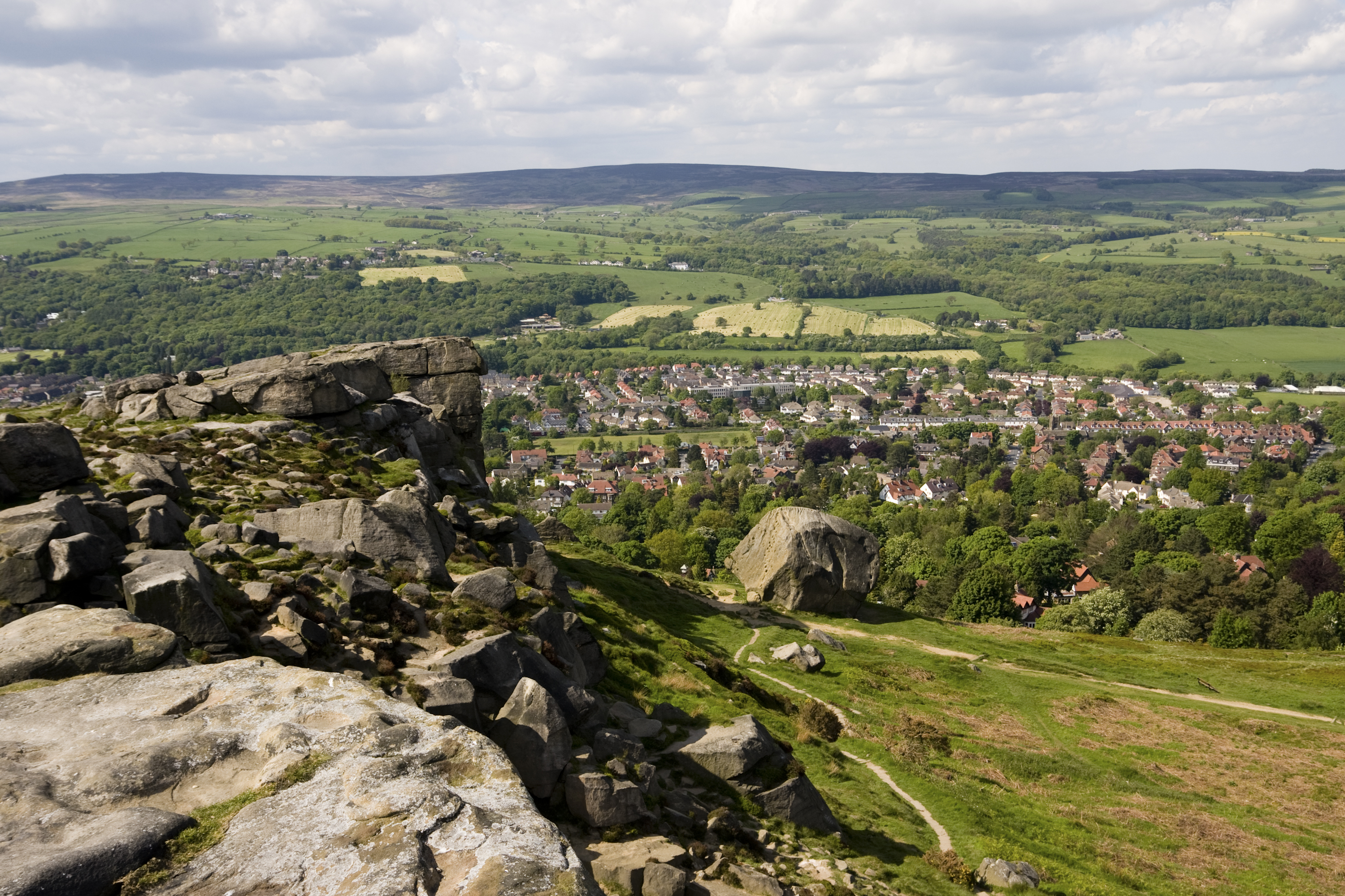 A photograph of Ilkley town overlooked from Ilkley Moor (Cow and Calf Rocks)