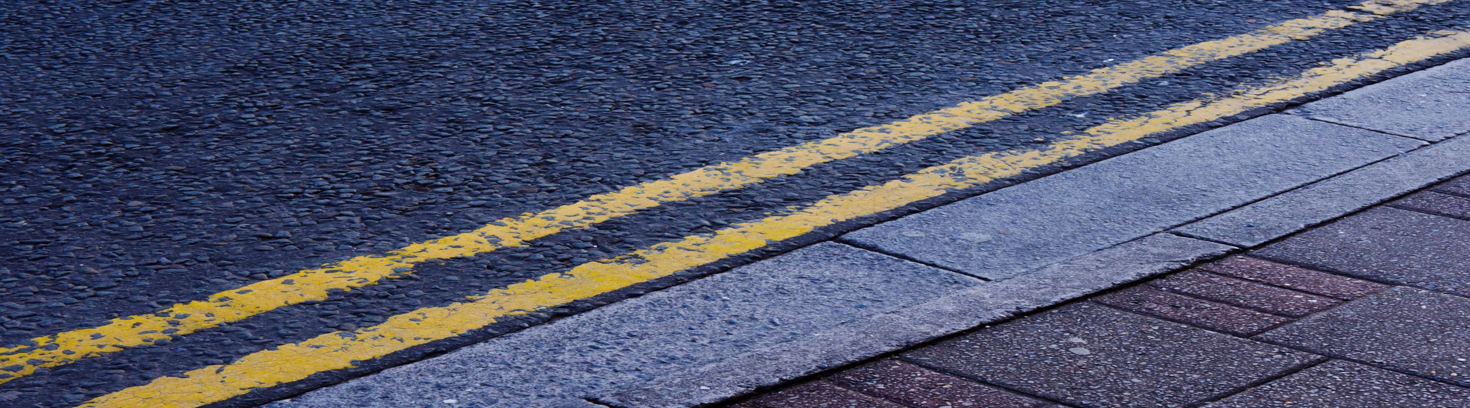 Photo of double yellow lines painted on road.