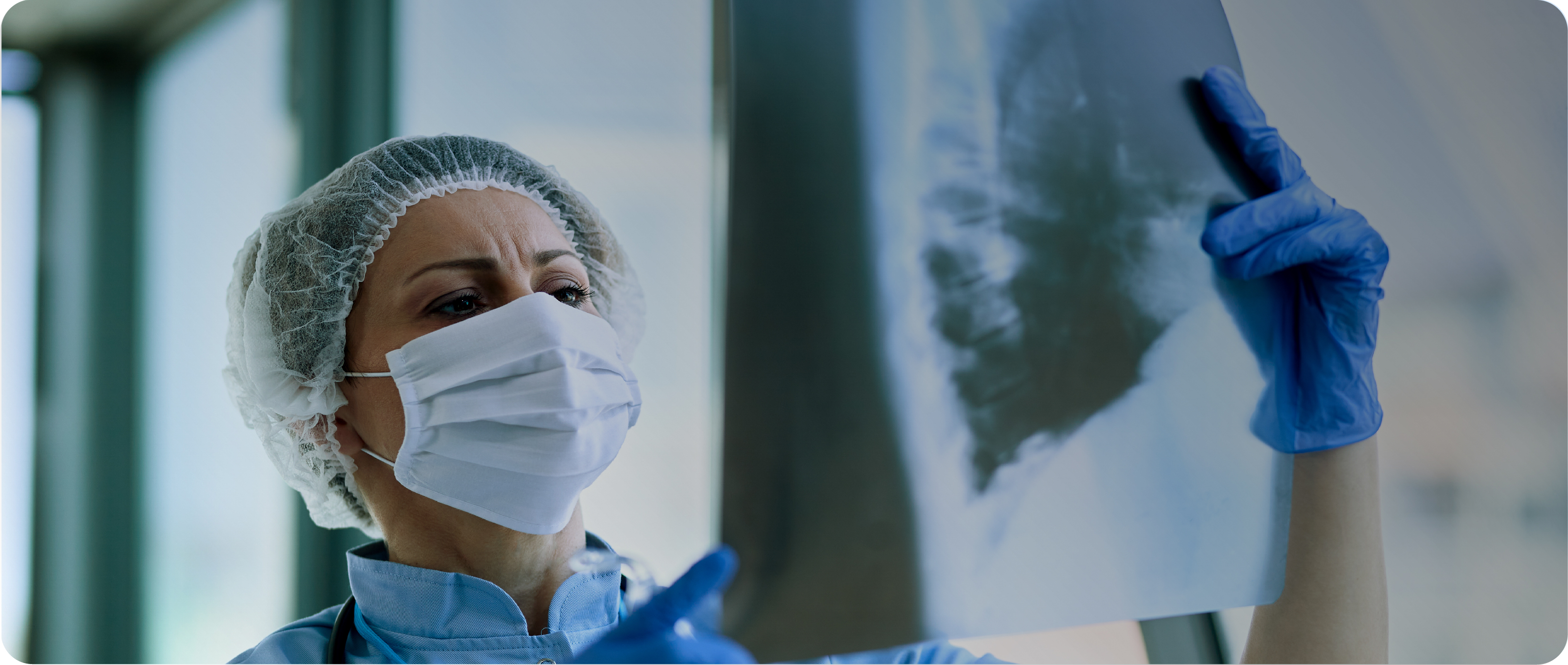 doctor with face mask looking at x-ray