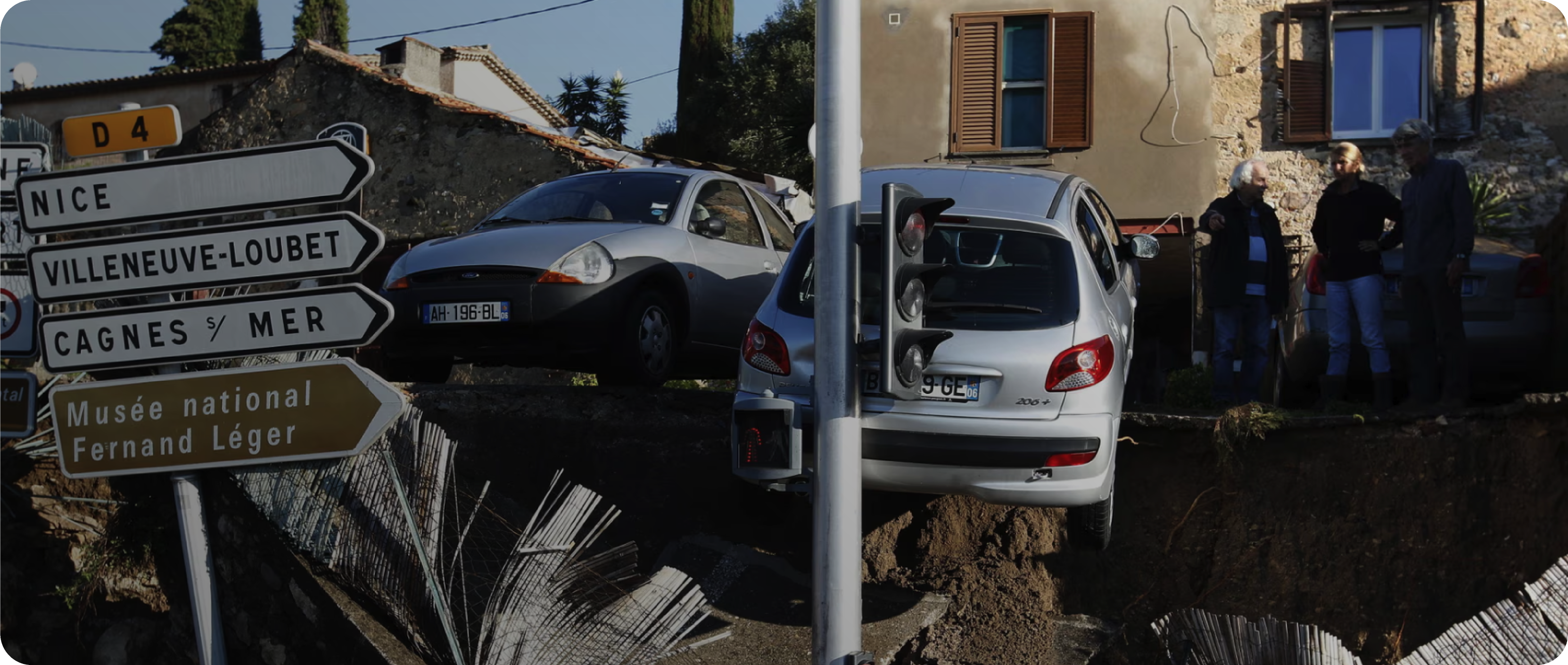 Cannes after 2015 flood, cars and damaged houses with street signs