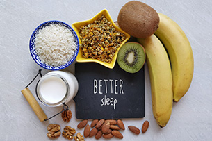 Wie Essen unseren Schlaf bestimmt Melatoninreiche Lebensmittel: Milch, Nüsse, Tee, Reis, Kiwi, Bananen mit Text "Better Sleep". Gesundes Essen für einen gesunden Schlaf