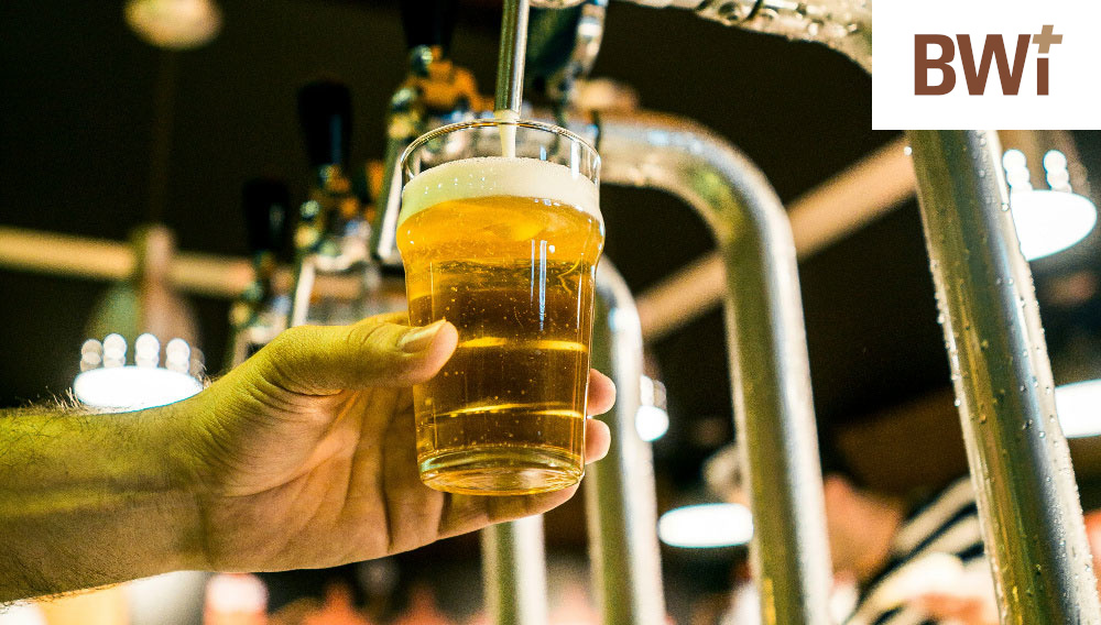 A glass with beer gets filled at a dispensing system (Photo: Fabio Alves on Unsplash)