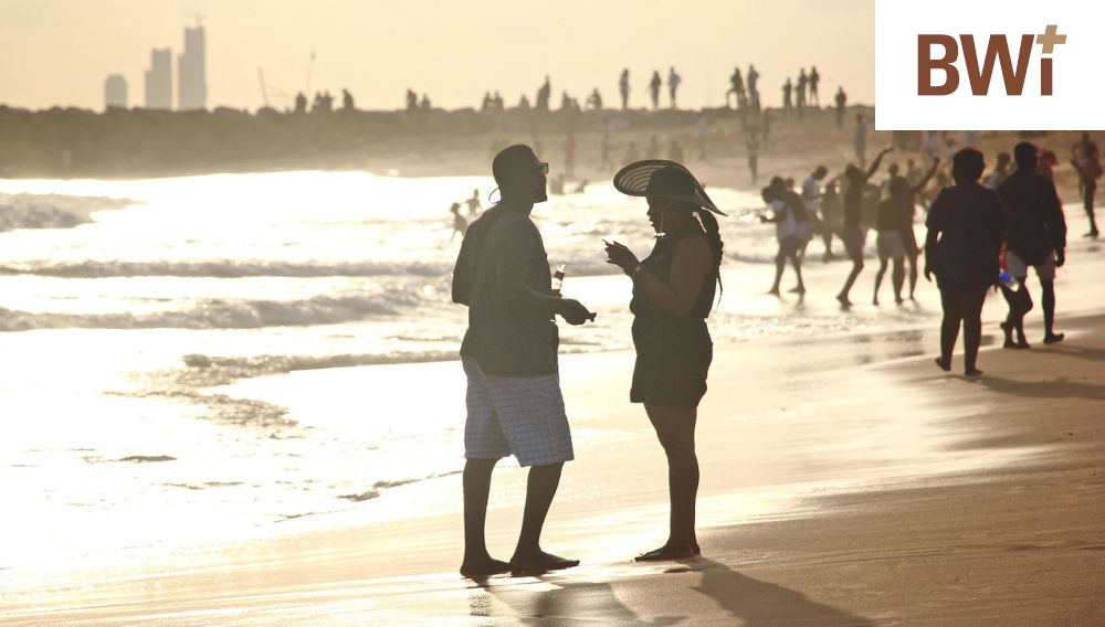People on a beach against the setting sun (Photo: Oladapo Olusola on Pixabay)