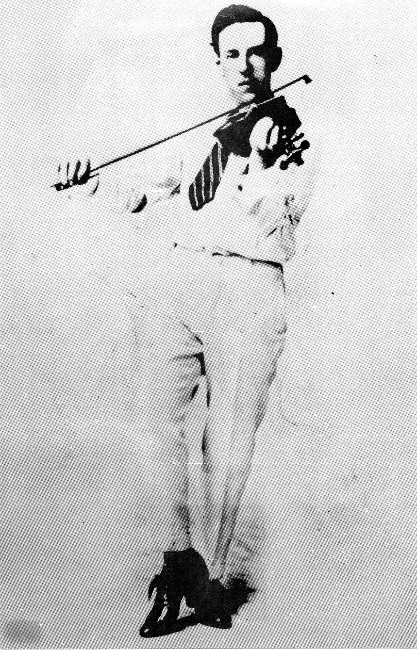 Black and white image of a man standing playing a fiddle.