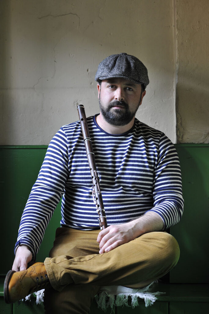 Barry Kerr sitting holding a flute