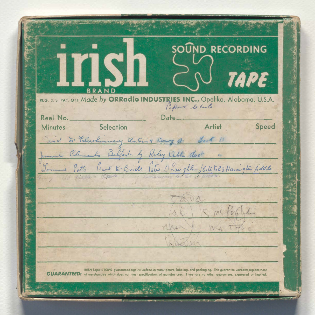 Old reel-to-reel tape case. It's green and white and says 'Irish sounds recording tape' on it.