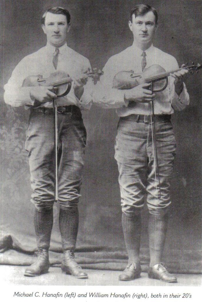 William and Micheal Hanafin standing holding fiddles