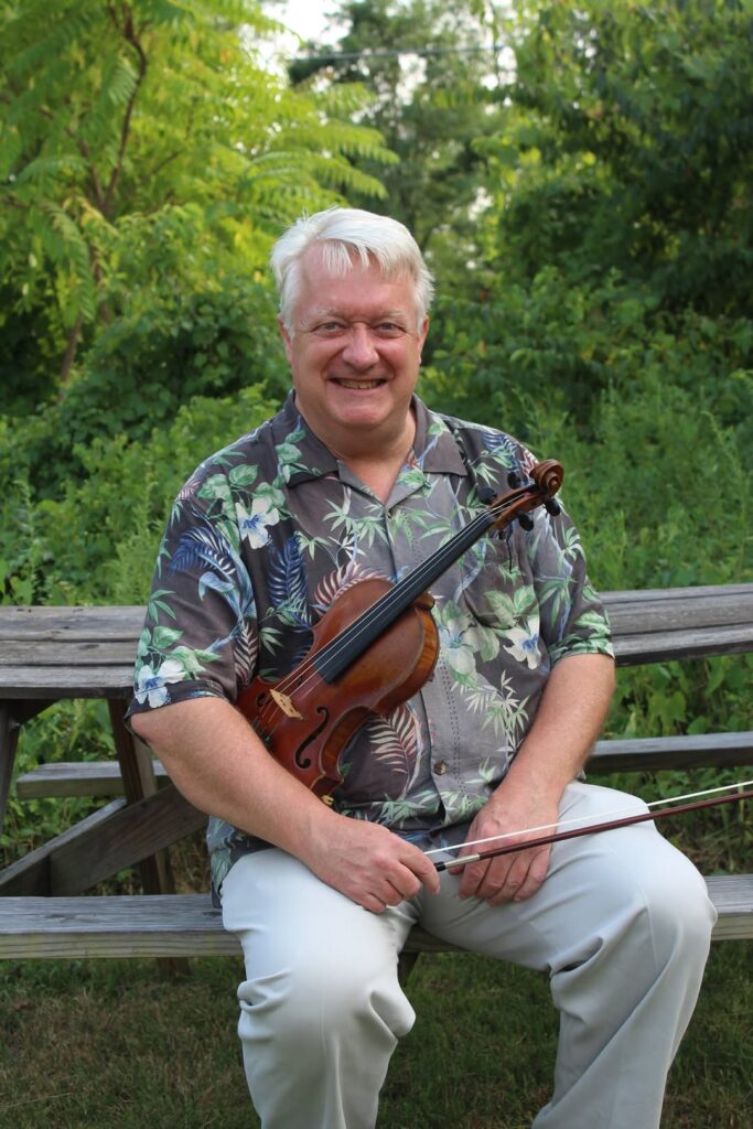 Mitch Fanning, seated holding fiddle