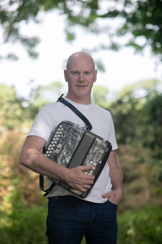 Gerald Culhane standing with his accordion