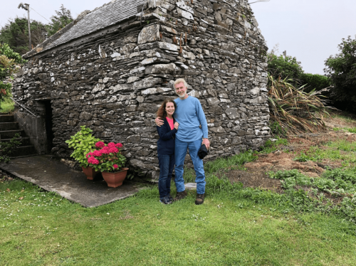 A picture of Jean and Paul, in front of a stone building on Cape Clear Island