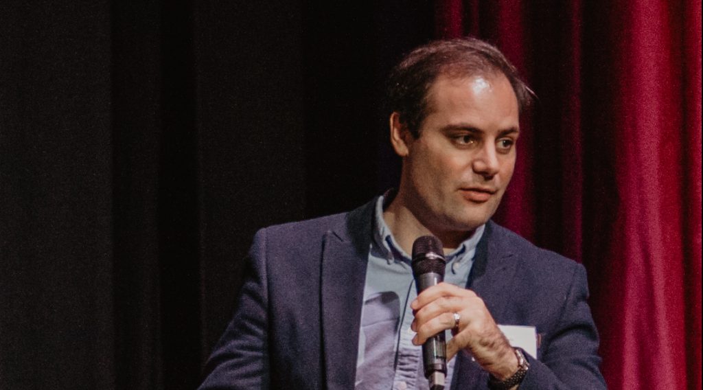 Ben Delo speaking about Bitcoin at a Spectator conference