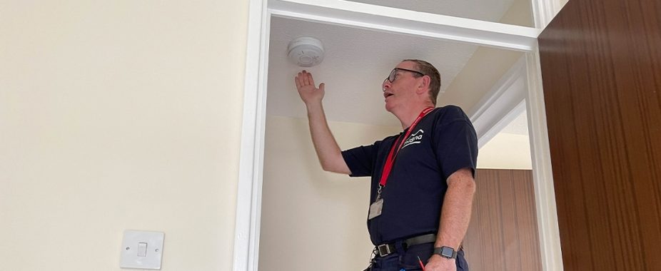 Magna colleague testing smoke alarm