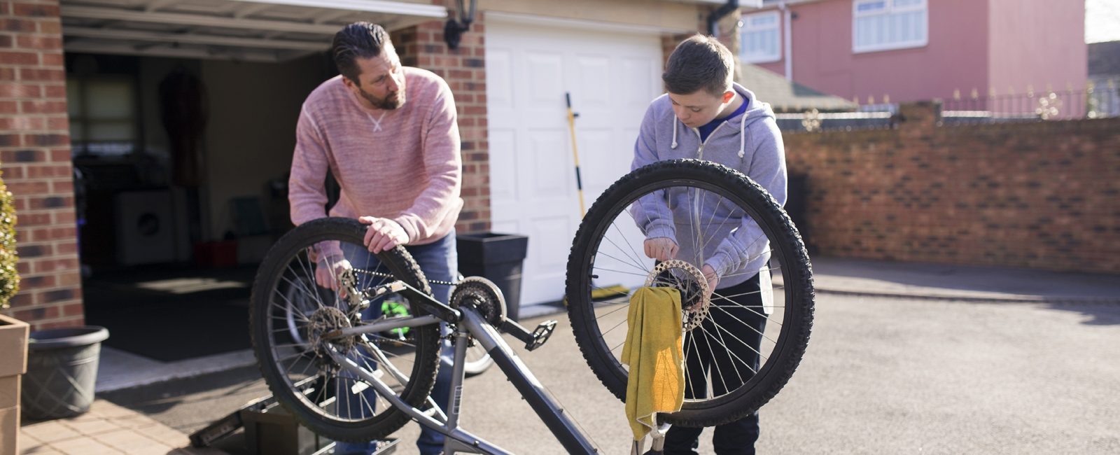 Stock father son fixing bike