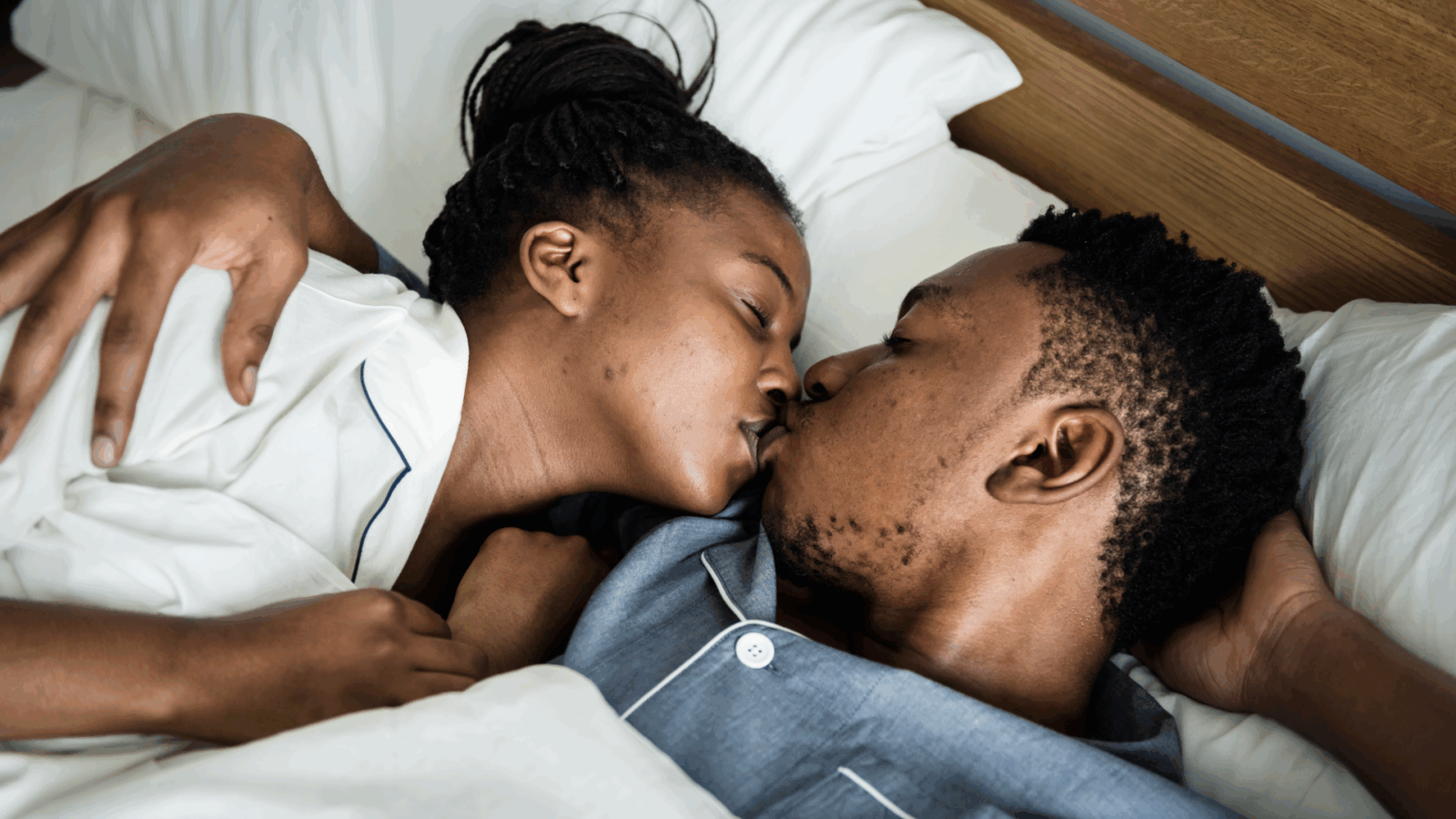 Couple kissing in bed by rawpixel.com via Freepik