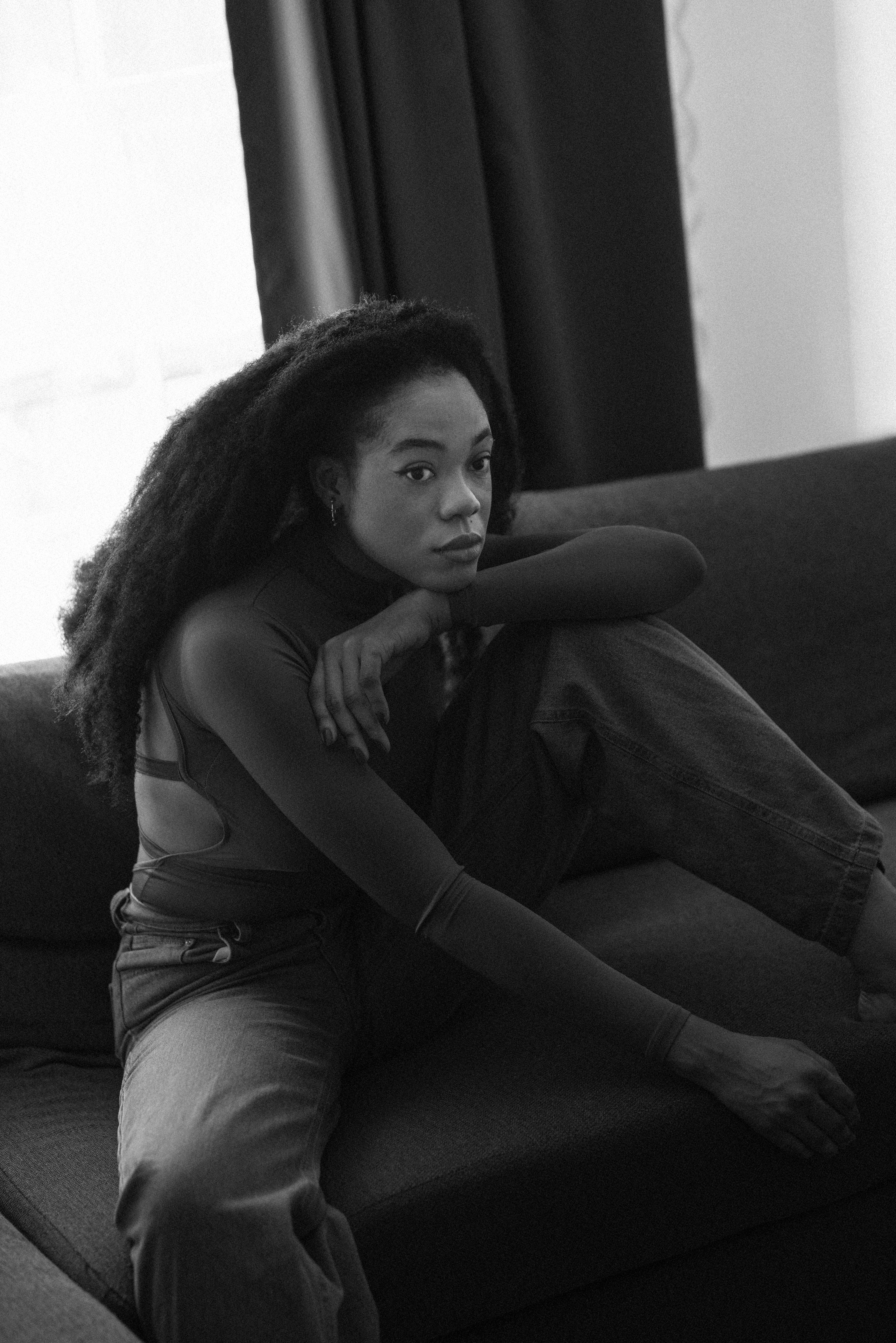 Woman sitting indoors in solitude via Freepik