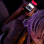 A woman on her phone by Radu Mihai via Unpslash+