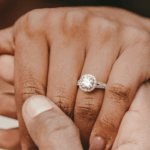 A woman's hand with a wedding ring being held by a man by Alekon Pictures via Unsplash+