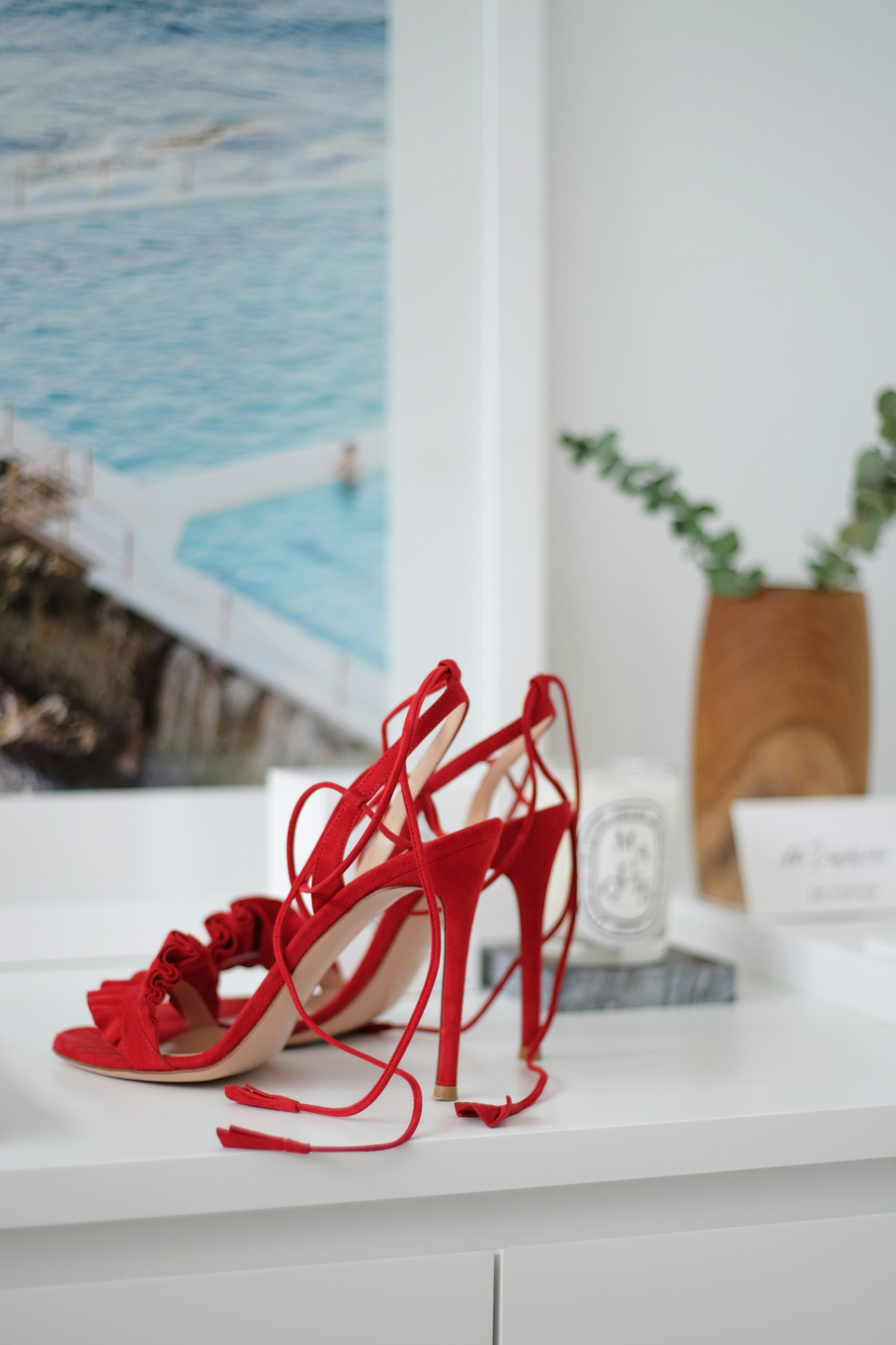 Dressing up - A dressy pair of red heels on a windowsill by Mona Siswanto via Unsplash+