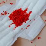 A close-up of an open pad with red beads in the middle by Kateryna Hliznitsova via Unsplash+