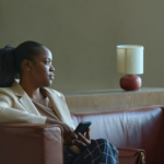 A black woman sitting alone looking forlorn via Getty Images from Unsplash+
