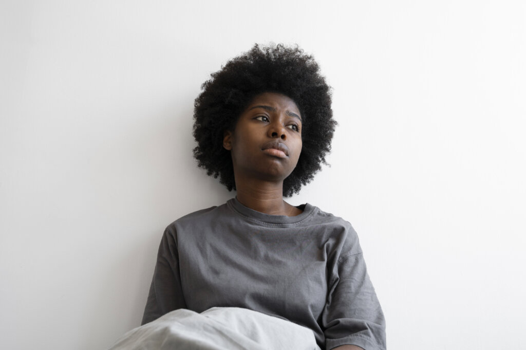 A young, depressed woman via Freepik