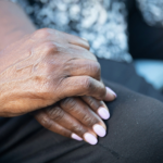 Two elderly hands entertwined by Nappy via Unsplash+