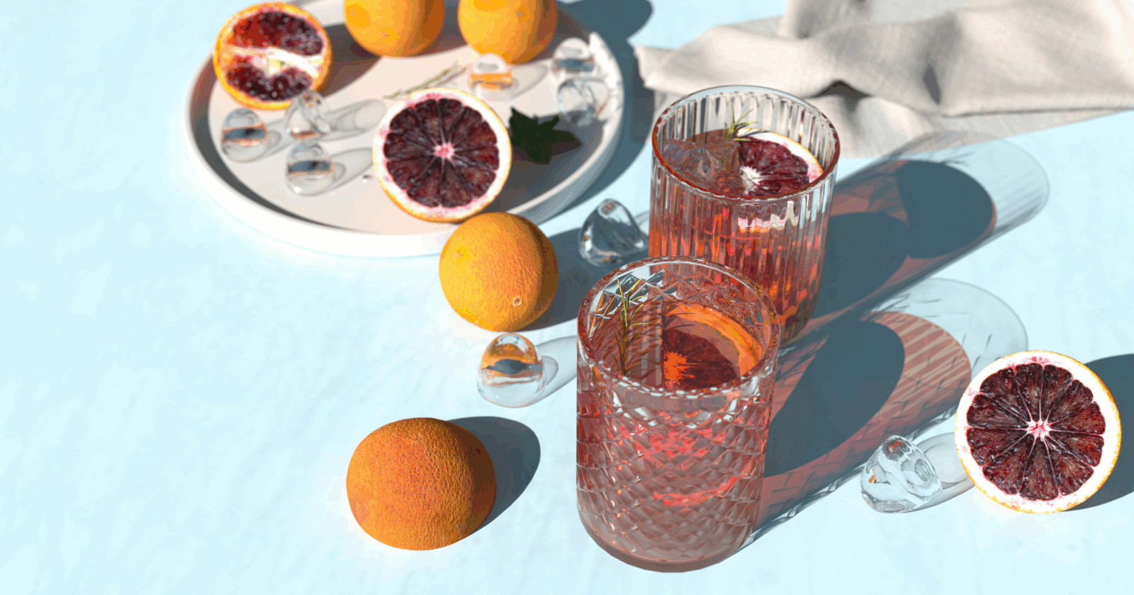 Two cocktails, some ice and some fruit by Alexander Mils via Unsplash