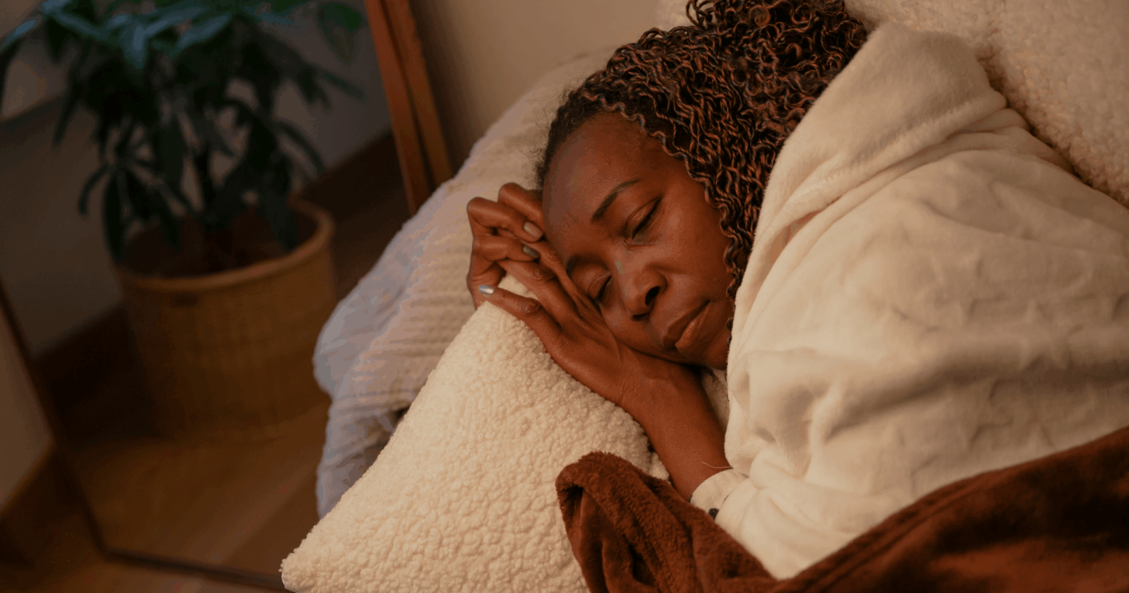 Fatigue: A black woman asleep in bed by Pablo Merchan Montes via Unsplash+