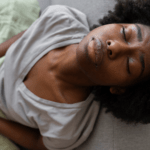 Black woman experiencing discomfort via Freepik