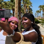 Chef Yo and her friend on holiday wearing the Topicals Faded Eye Mask via @tthatchefyo on Instagram