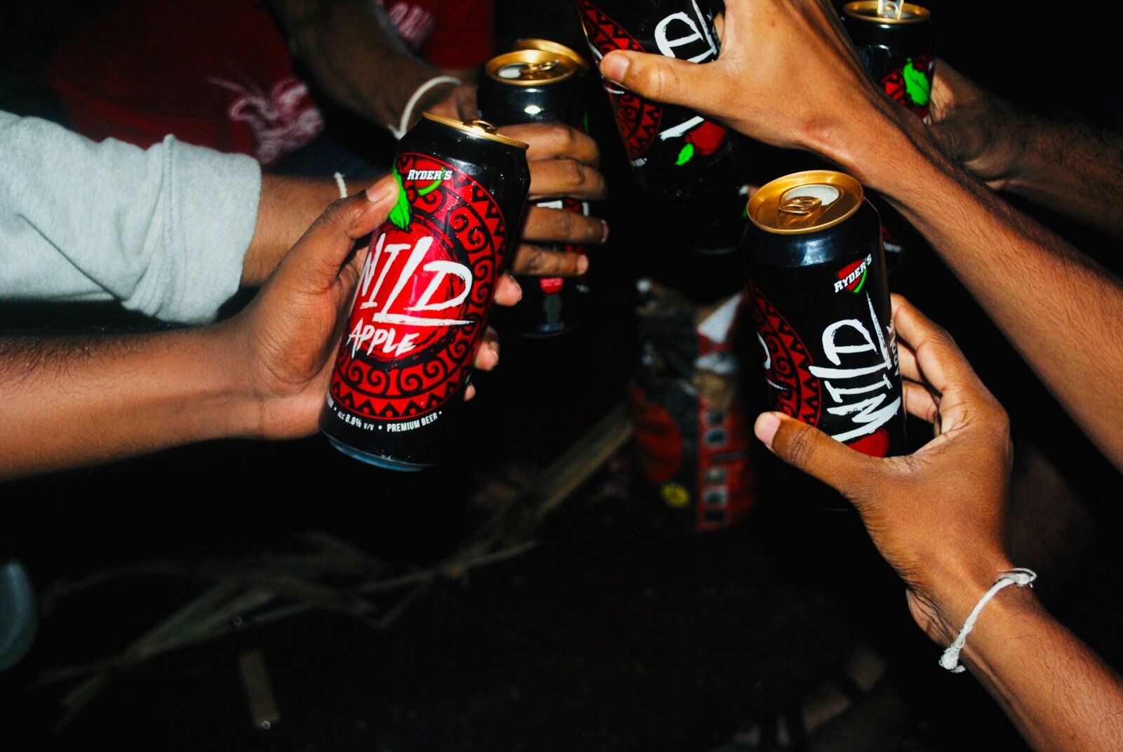 A collective toast with cans of beer by Ashan Harsha via Unsplash