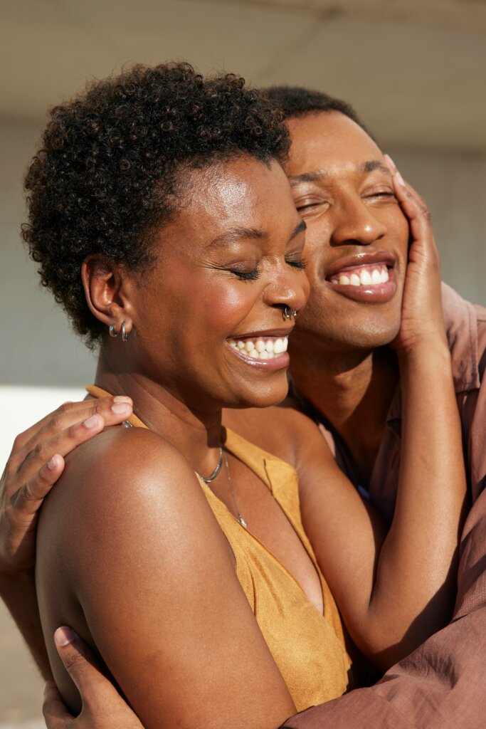 People embracing each other and smiling by Natalia Blauth via Unsplash