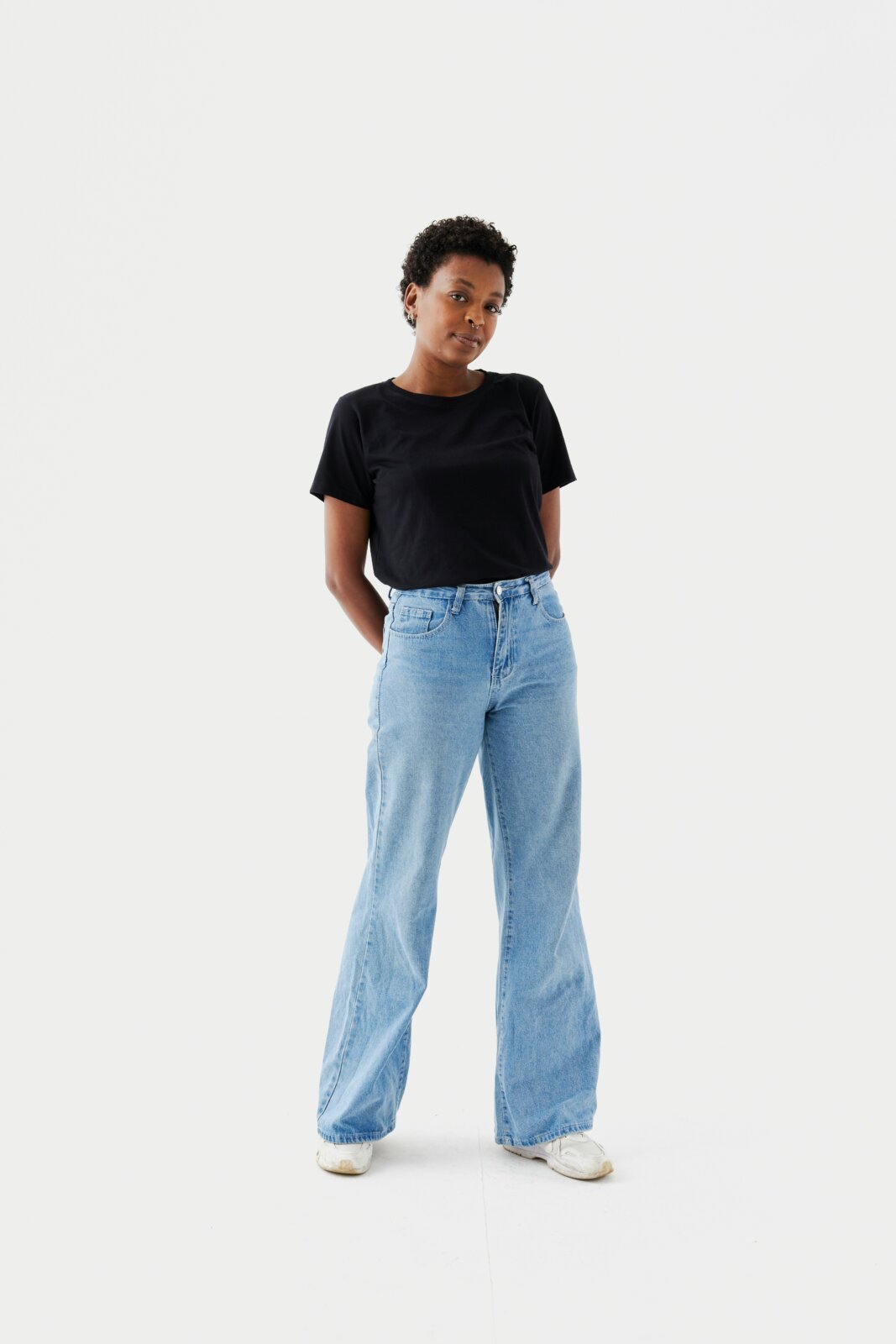A black model wearing jeans by Natalia Blauth via Unsplash+