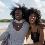 Black women embracing and smiling by Thought catalog via Unsplash