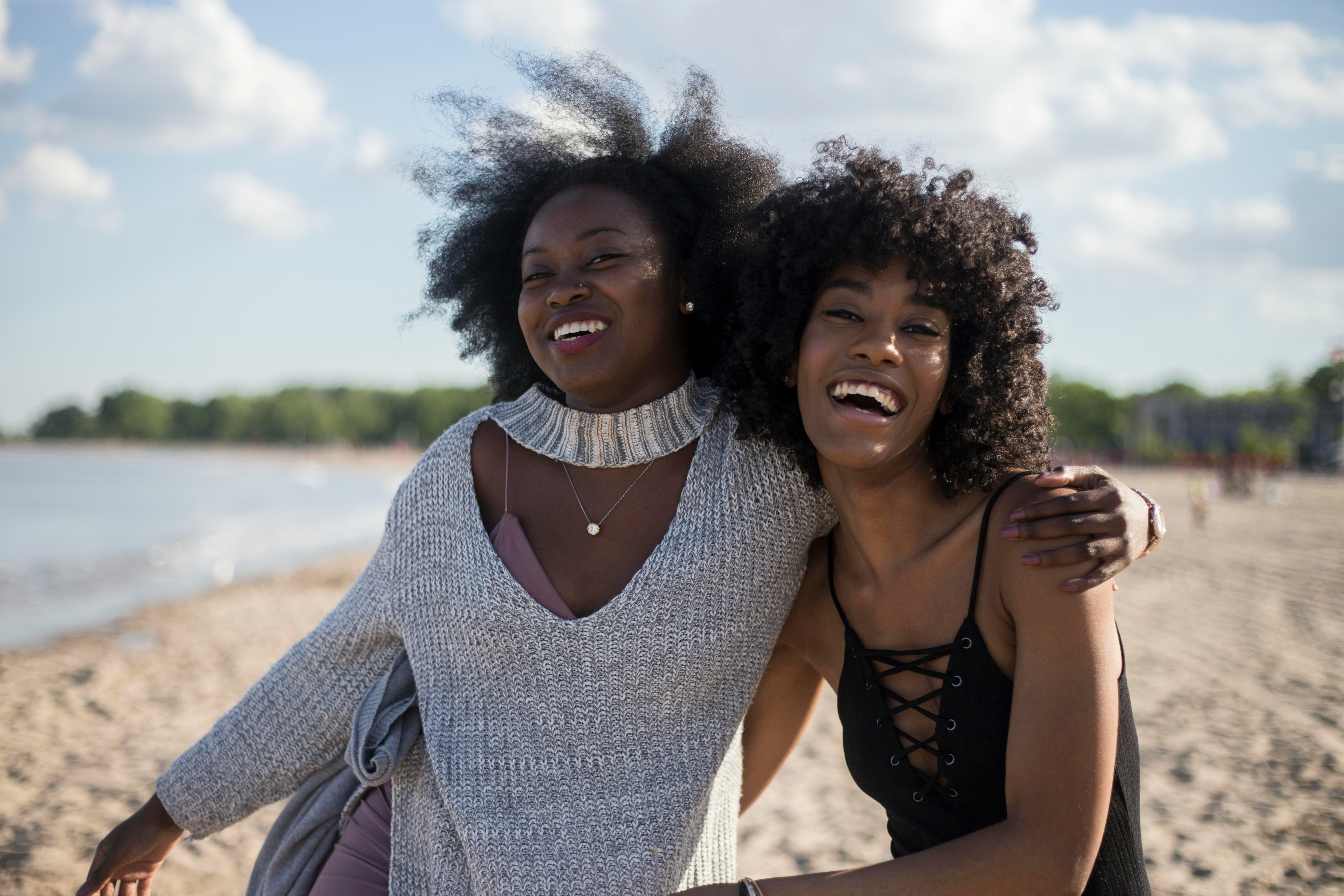 Black women embracing and smiling by Thought catalog via Unsplash