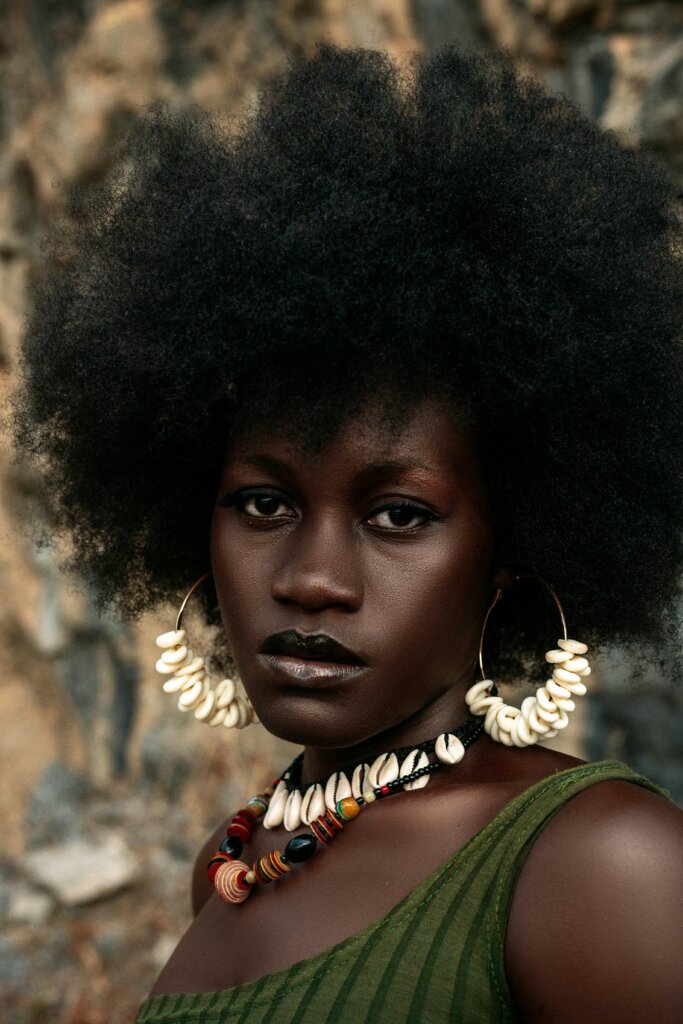 Dark-skinned woman with an afro by Godfrey Kwakye via Unsplash
