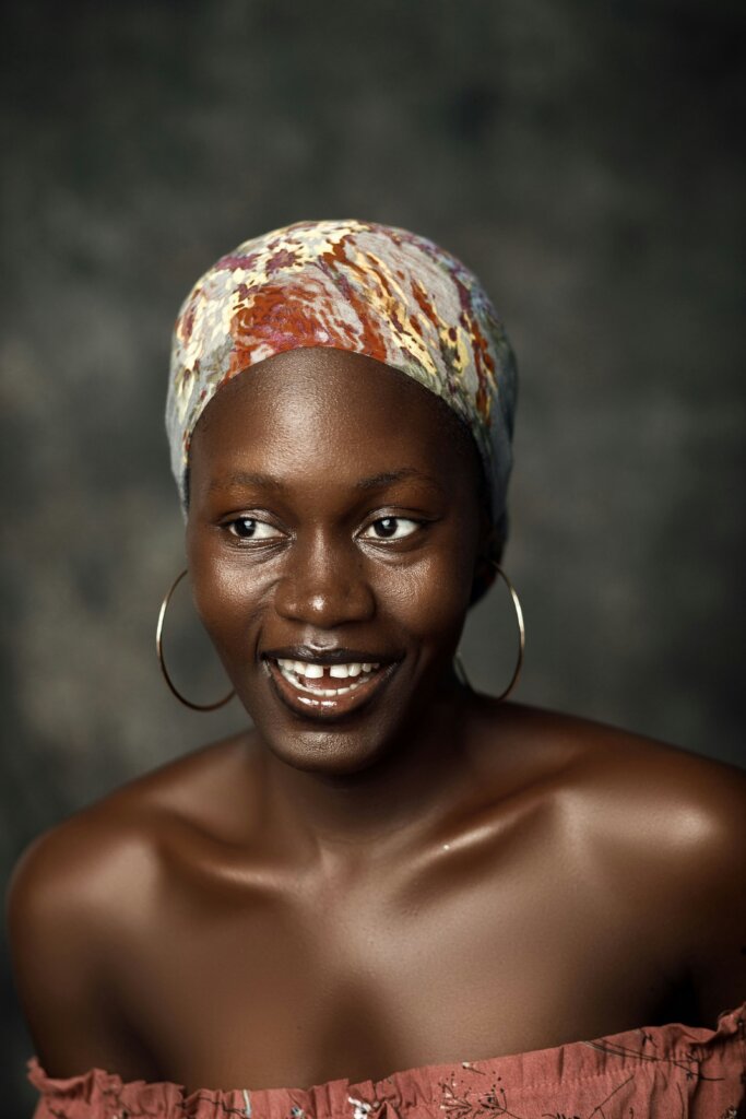 Dark-skinned woman smiling by Godfrey Kwakye via Unsplash