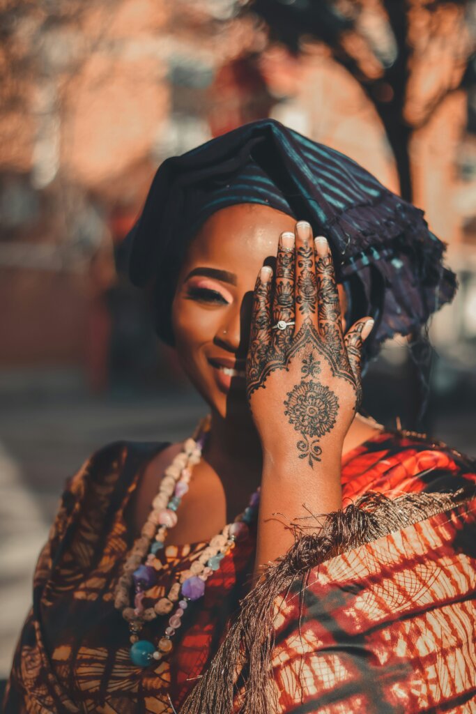 Black woman with Henna drawing on her hand by Ibrahima Toure via Unsplash