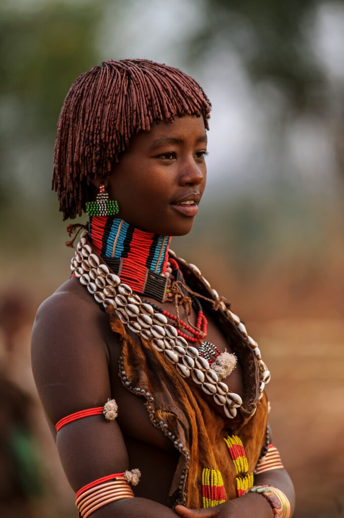 Ethiopian woman wearing beaded jewellery and cowries by Sammy Wong via Unsplash