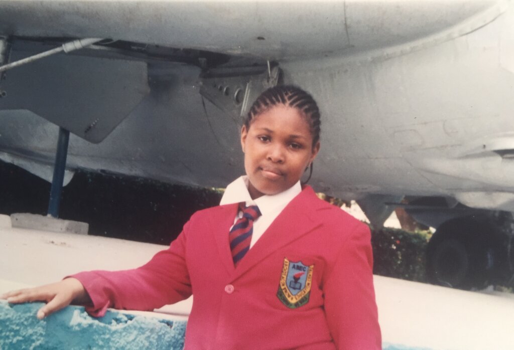 Me at the National War Museum, Umuahia, sometime in 2008 (before my dad’s passing). I am wearing a white shirt, striped tie, and red blazer, and my hair is in cornrows.